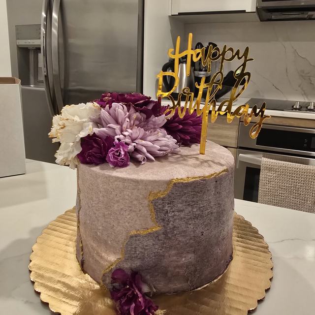 Purple birthday cake with flowers